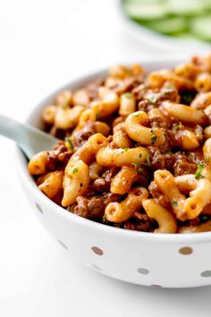 a white bowl filled with pasta and meat