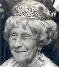 an older woman wearing a tiara and smiling