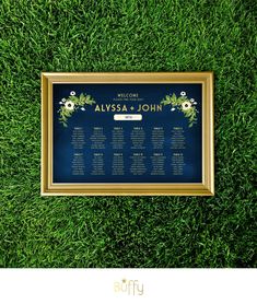 a wedding seating chart is placed on the grass in front of a gold frame with flowers