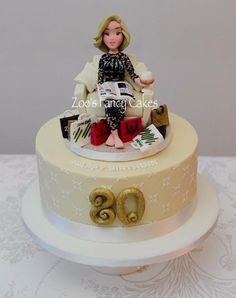 a birthday cake with a woman sitting on top of it and celebrating her 90th birthday