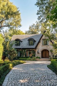 a stone driveway leading to a large house