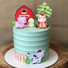 a blue cake with farm animals on top