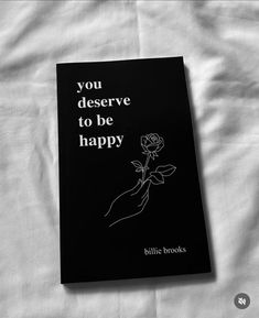 a book that is laying on top of a bed with the words you deserves to be happy