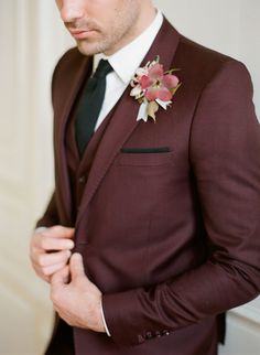 a man in a suit and flower boutonniere