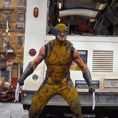 a man dressed as wolverine stands in front of a bus