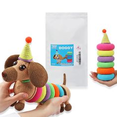 a person holding a dog toy and stacking it up with other toys in front of them