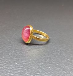 *Ring with pink tourmaline stone, domed, with inclusion. Cabochon. *Stone size: 13MMX10MM rectangle shape * The setting is in 925 hallmarked gold-plated silver *Ring size 54 * Free delivery by post by registered letter * Ring delivered in its protective box * Instagram _atelier768_ * Unique piece Rectangular Tourmaline Gemstone Ring, Pink Cabochon Ruby Ring, Pink Round Cabochon Ruby Ring, Pink Oval Ring With Large Stone, Oval Pink Ring With Large Stone, Handmade Pink Ruby Rings, Oval Pink Tourmaline Ruby Ring, Formal Pink Rings With Rectangular Stone, Pink Oval Ring With Bezel Setting