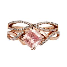 a pink diamond ring with two rows of diamonds around it and an intertwined band