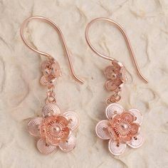 Double your fun with this gorgeous pair of flower earrings from Bali's Yuniati. Crafted from 18k rose gold plated sterling silver filigree each dangle earring features two stacked flowers with round petals in a combination finish. Rose Gold Earrings With Rose Flower Design, Rose Gold Flower-shaped Jewelry With Matching Earrings, Rose Gold Sterling Silver Filigree Jewelry, Pierced Rose Gold Flower Earrings, Filigree Flower Earrings, Rose Gold Filigree Dangle Jewelry, Rose Gold Dangle Flower Earrings In Sterling Silver, Rose Gold Dangle Earrings With Flower Charm, Rose Gold Dangle Flower Earrings