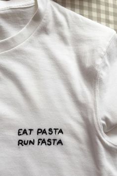 a white shirt that says eat pasta run fast