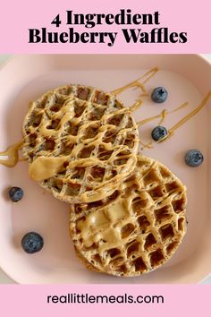 three blueberry waffles on a plate with syrup drizzled over them