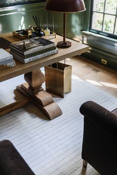 a living room with a couch, chair and table in it's center area