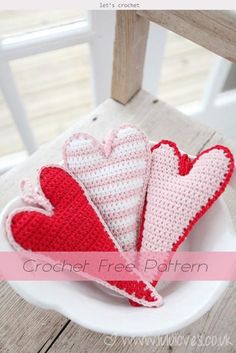 three crocheted hearts sitting on top of a white plate