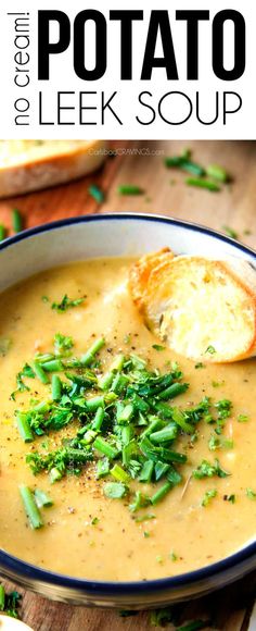 a bowl of potato leek soup on a wooden table with bread and parsley