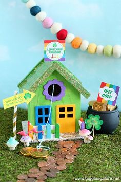 a small green house sitting on top of a pile of coins