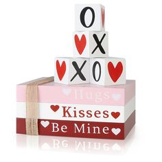 a stack of valentine's blocks with the words hugs kisses be mine