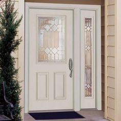 a white front door with stained glass panels