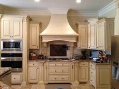 a kitchen with white cabinets and an oven