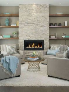 a living room filled with furniture and a fire place in the middle of the room