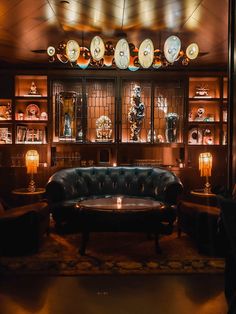 a living room filled with furniture and lots of clocks