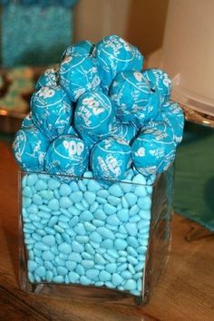 blue candies in a clear container on a table