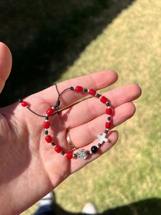 Beautifully handmade red & black decade rosary bracelet. If you're a Texas Tech fan/Alumn like myself, this would be perfect!  DETAILS Size: 6in-10in Material: Nylon Stone: Faux Red Coral Metal: Silver plated Pendant: Benedictine Pendant & Cross Decade Rosary, Lubbock Tx, Catholic Rosary, Rosary Bracelet, Rosary Catholic, Texas Tech, Bracelet Handmade, Prayer Beads, Red Coral