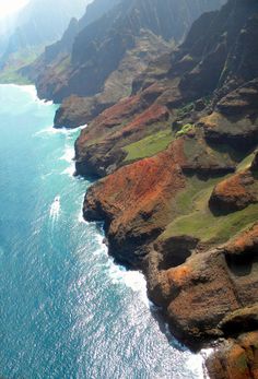 an aerial view of the ocean and cliffs