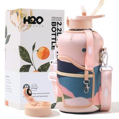 a pink and blue lunch bag next to a white box with an orange on it