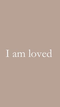 the words i am loved written in white on a beige background