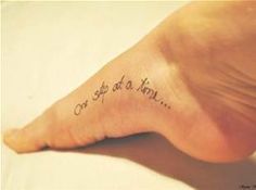 a person's foot with a tattoo that says, come at a time on it