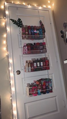 a pantry door is decorated with christmas lights and shelves filled with spices, condiments, and other items