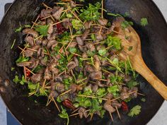 a skillet filled with meat and veggies