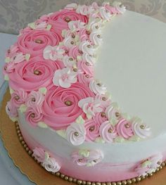 a cake decorated with pink and white flowers