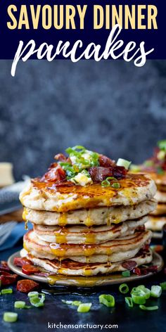 a stack of pancakes with bacon and cheese on top