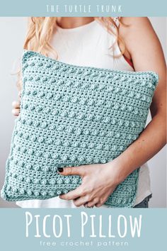 a woman holding a crocheted pillow with the text, the turtle trunk picot pillow free crochet pattern