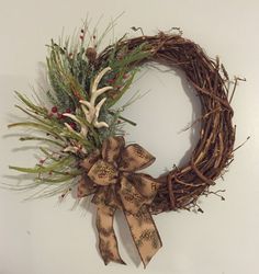 a wreath with deer antlers and berries on it