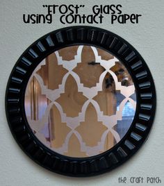 a mirror that is on the wall with an image of a pattern in front of it