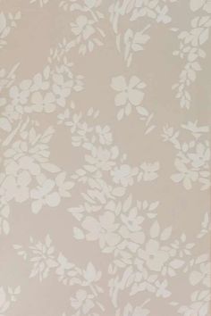 a white flowered wallpaper on a beige background