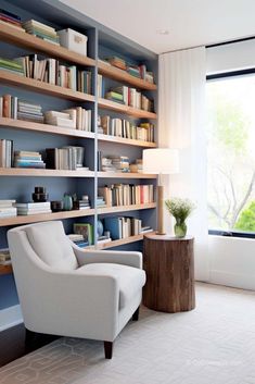 a living room filled with lots of furniture and bookshelves next to a window