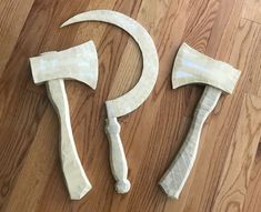 two white plastic hammers sitting on top of a wooden floor