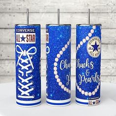 three blue glittered canisters with the words chuck's and pearls on them