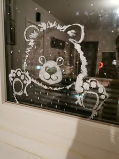 a teddy bear drawn on the window sill