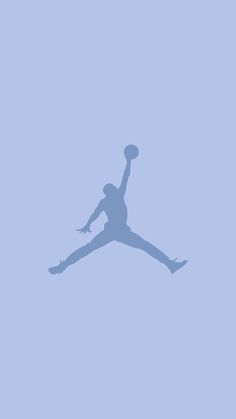 the silhouette of a basketball player jumping in the air