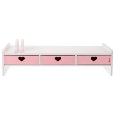 a white bench with pink drawers and two hearts on the top, against a white background