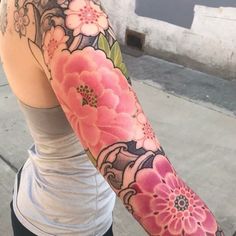 a woman with a flower tattoo on her arm