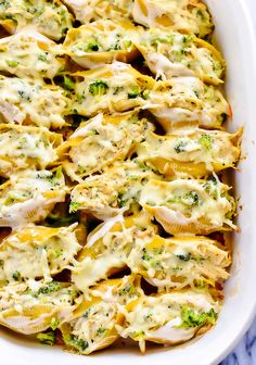 a casserole dish with chicken and broccoli covered in melted cheese on top