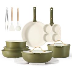 an assortment of green pots and pans with utensils