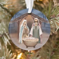 a christmas ornament with two women and a baby in a manger scene