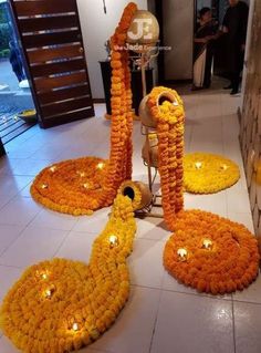 an arrangement of flowers and candles on the floor