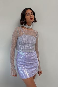 Prepare to be the center of attention with our Hands Off Silver Rhinestone Top! This stunning piece is an absolute showstopper, with rhinestone mesh fabric that covers every inch. The sheer fabric demands attention, while the long sleeves keep you looking effortlessly glamorous. STYLE RECOMMENDATIONS: - Pair with a bralette or tank underneath. Recommend to pair with Jaxon Black trousers or Halley trousers﻿ for a night out! PRODUCT DESCRIPTION AND MATERIALS: - light grey/blue long sleeve mesh cro Evening Mesh Top With Rhinestones, Crystal Mesh Top, Fitted Glamorous Mesh Top With Rhinestones, Black Mesh Rhinestone Top, Rhinestone Mesh Top Long Sleeve, Light Grey Blue, Rhinestone Skirt, Sheer Long Sleeve Top, Rhinestone Top